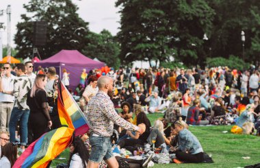 Helsinki Pride festivalinde büyük gökkuşağı bayrağı olan adam
