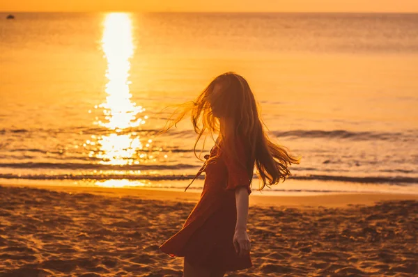 Young blonde girl in red dress dancing in the evening — Stock Photo, Image