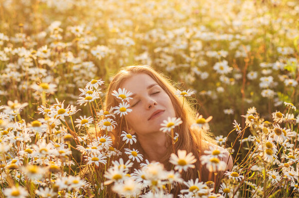 Portrait of pretty blond woman with closed eyes sitting in chamo