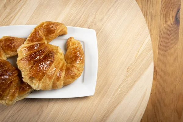 Kruvasan üzerinde beyaz tabak üstten görünüm