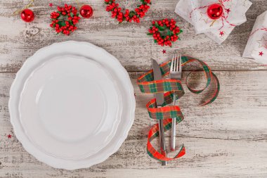 Beyaz ahşap masa üzerinde Noel ve yeni yıl süslemeleri ile kış yer ayarı. Noel yemeği için festival tablo ayarı.