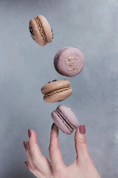 Galletas Dulces Macarrones Franceses Cayendo Mano Mujer Sobre Fondo Gris —  Fotos de Stock