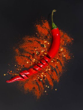 Raw fresh organic, red pepper flakes and dried ground chili pepp clipart