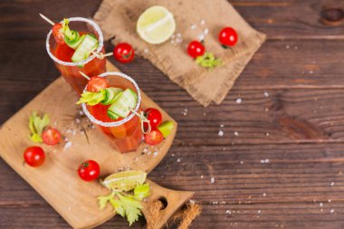 İki bardak domates suyu taze domates, cucum ile dekore edilmiştir.