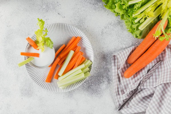 Vegetable sticks. Fresh celery and carrot with yogurt sauce. Healthy and diet food concept.