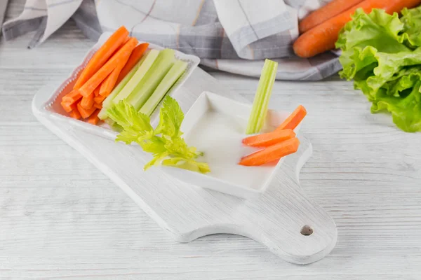 Vegetable sticks. Fresh celery and carrot with yogurt sauce. Healthy and diet food concept.