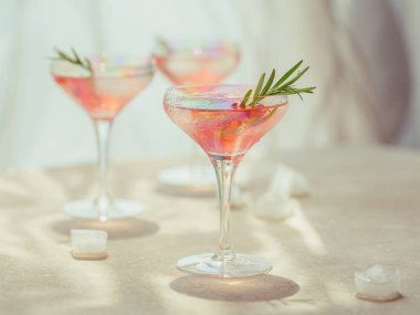 Glass of strawberry cocktail or mocktail, refreshing summer drink with crushed ice and sparkling water on light background.  clipart