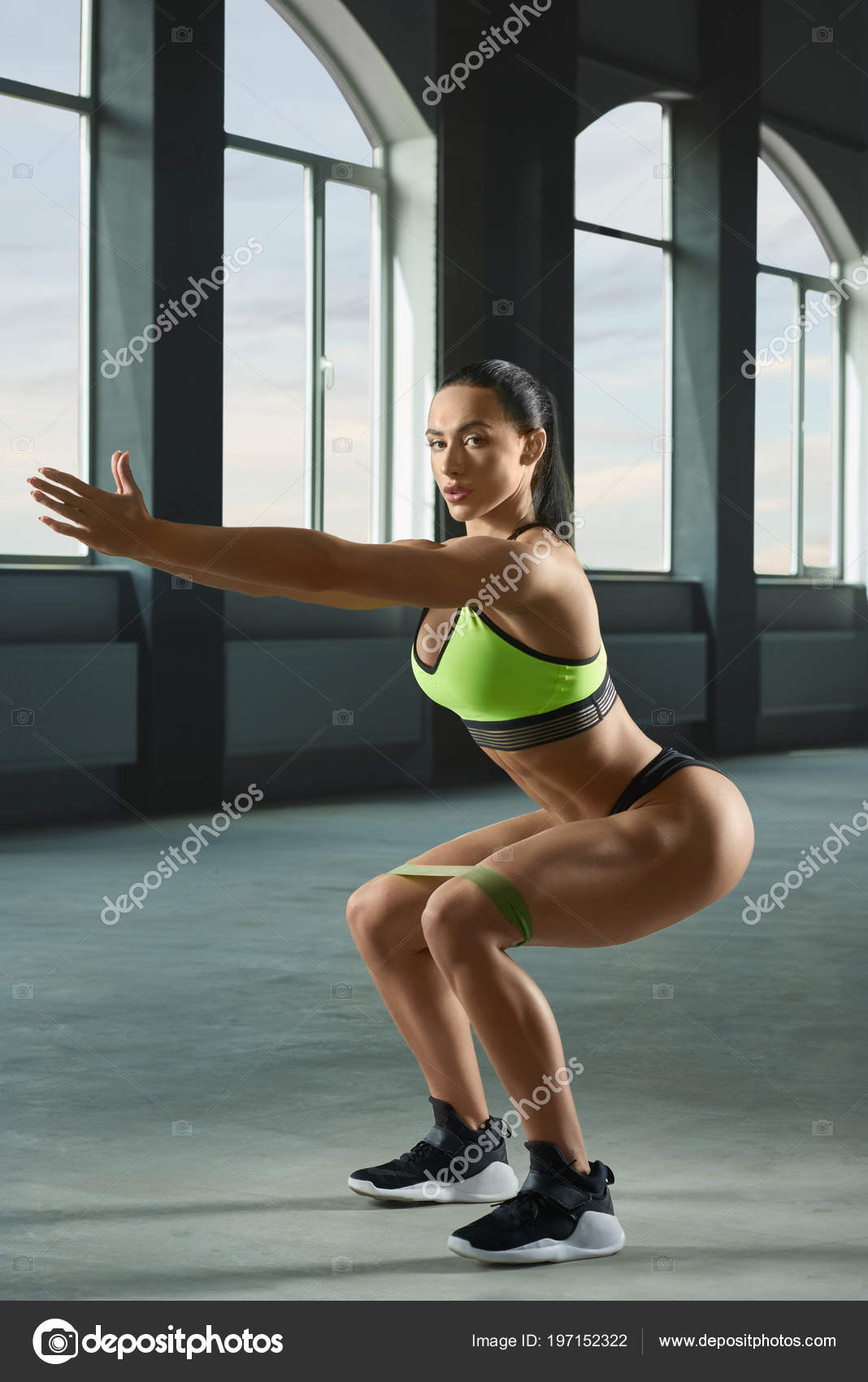 Attractive athletic muscular woman is doing side body bend
