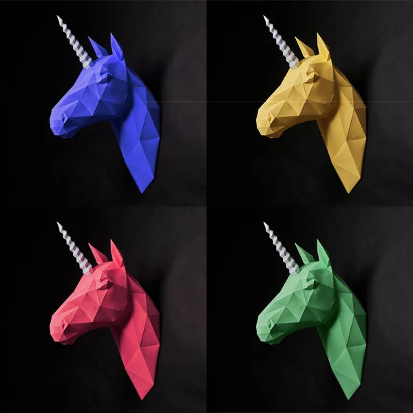 Colorful unicorns made from paper on black background.