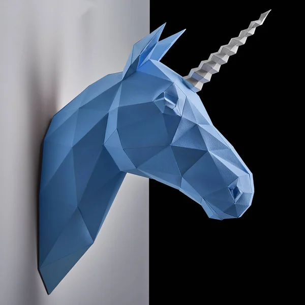 Blue unicorns head hanging on grey shadowed wall. — Stock Photo, Image