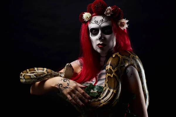 뱀 피 긴 손에 들고 머리에 얼굴과 꽃 그리기 괴물 여자. — 스톡 사진