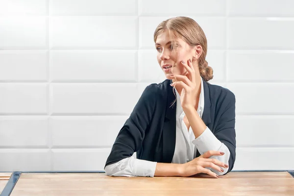 Front view of attractive woman looking aside and posing with new manicure.