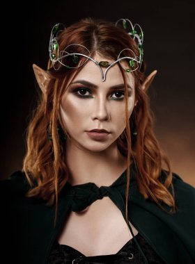 Koyu yeşil gizli kameraya bakarak harika kadın. 