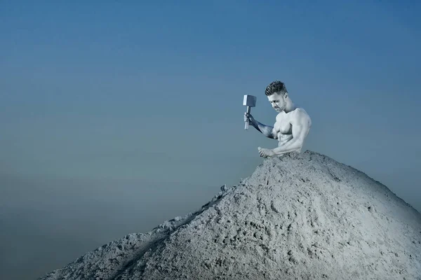 Man with silver skin saving himself from big mountain. — Stock Photo, Image