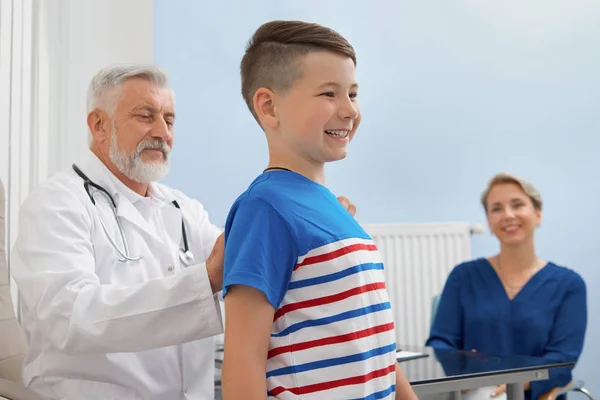 Médico mirando la postura del niño en la clínica privada . —  Fotos de Stock