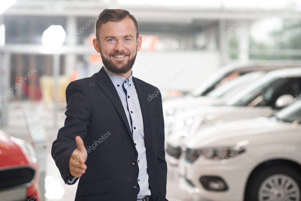 Manager of car center showing thumb up.