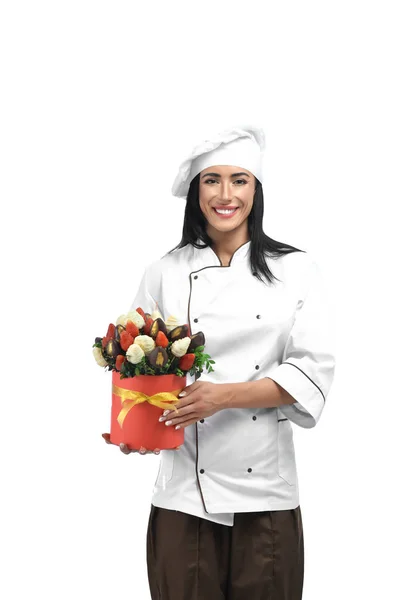 Pastry cook doing presents from sweets and fruits.