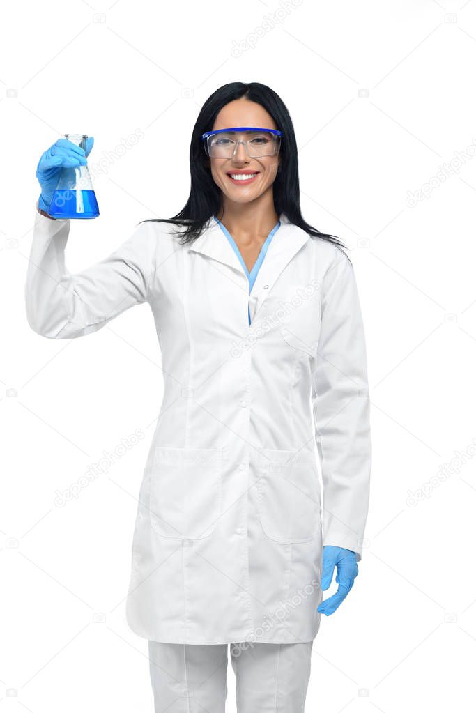Young beautiful chemist working with dangerous liquids.