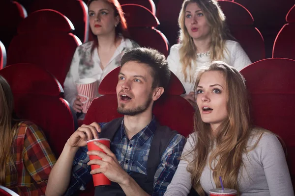 Shocked couple looking at screen in cinema. — Stock Photo, Image