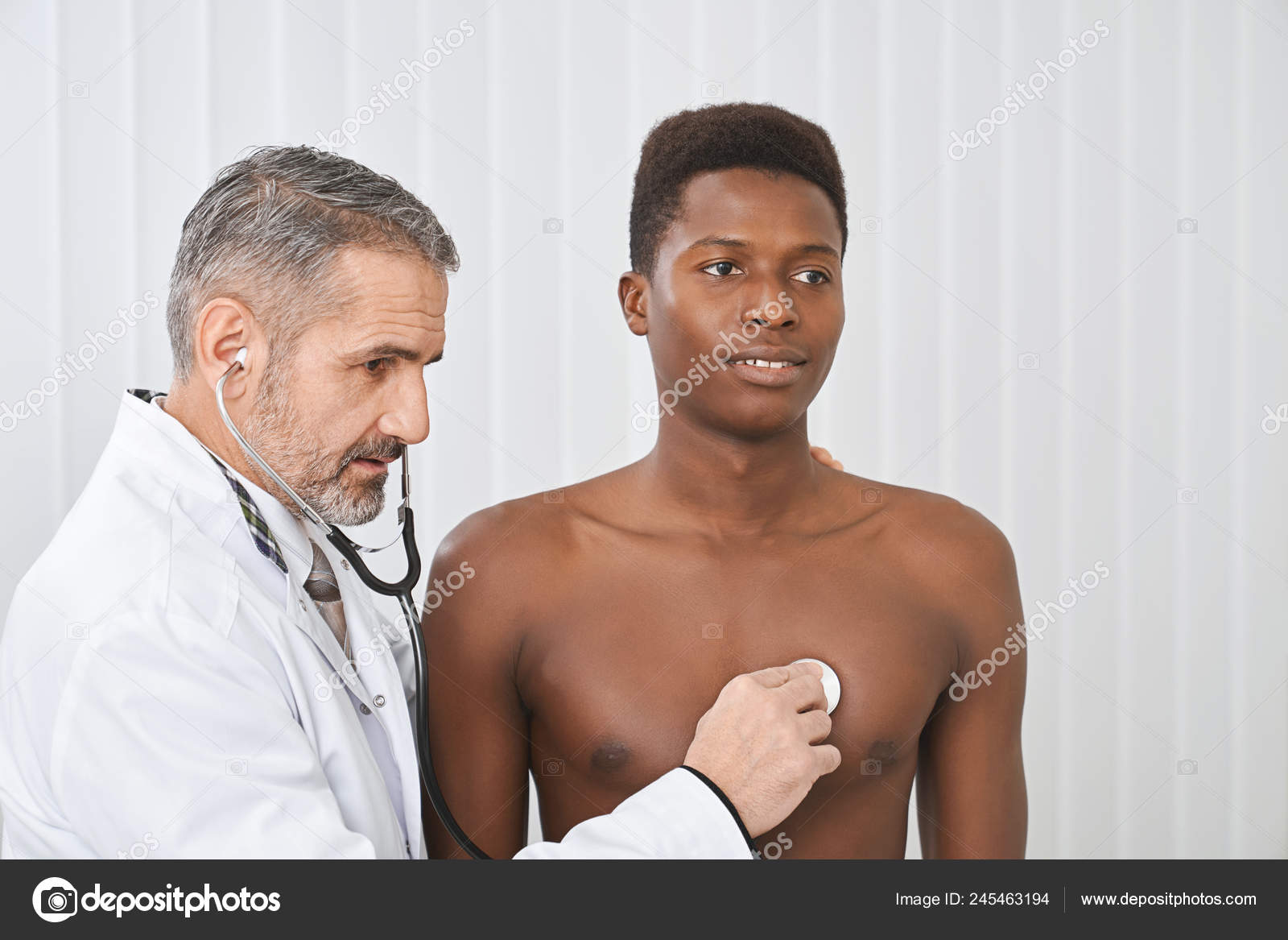 Doctor listening heart beat of male patient. Stock Photo by  ©serhii.bobyk.gmail.com 245463194
