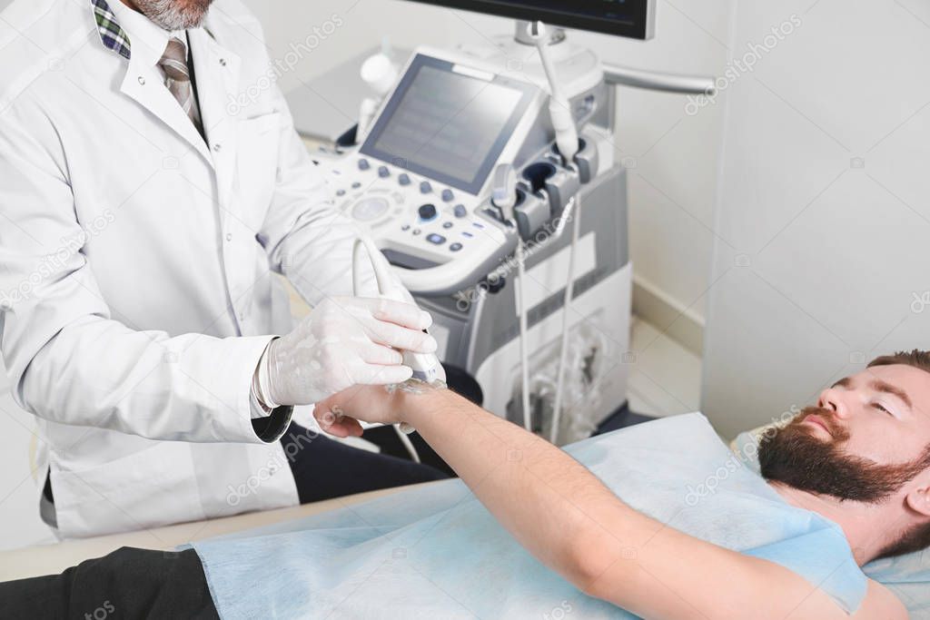 Male patient lying on ultrasound diagnostics.