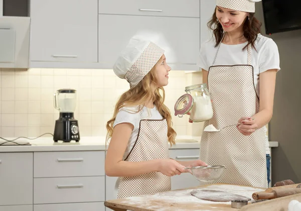 Mãe e filha cozinhar pastelaria caseira na cozinha . — Fotografia de Stock