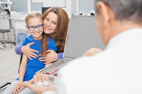 Doctor offering contact lenses to clients.