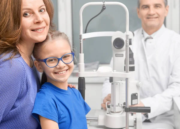 Pazienti sorridenti, in posa con oftalmologo in clinica . — Foto Stock