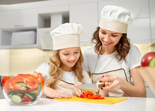 Familie snijden groenten samen in de keuken — Stockfoto