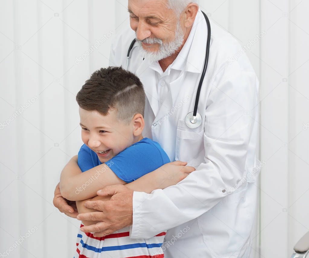 Doctor showing exercises to boy on consultation.