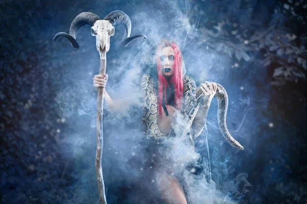 Witch with big snake holding staff with ram skull. — 스톡 사진