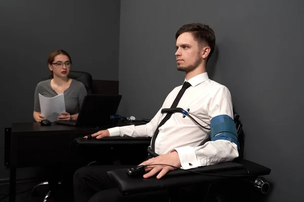 Woman examinating man with lie detector. — 스톡 사진