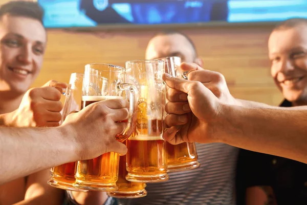 Selective focus of glasses of beer in hands of male friends — Stock Photo, Image