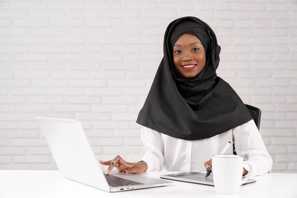African muslim business lady working on computer in office.