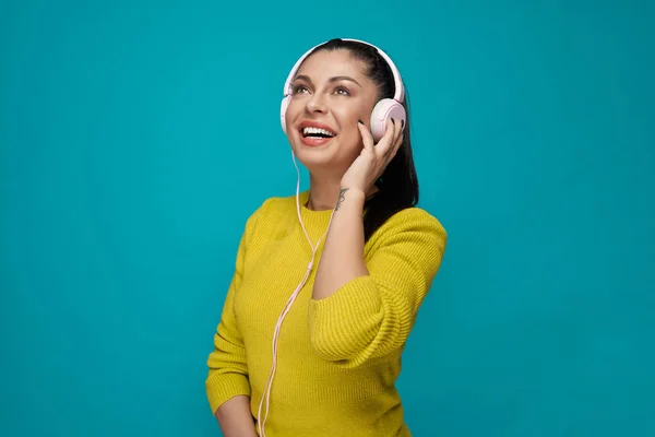 Happy model listening music in headphones.