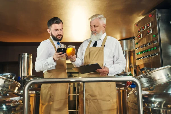 Vista frontal de cerveceros que trabajan en fábrica de fabricación de cerveza —  Fotos de Stock