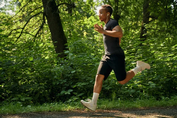 Athlete running marathon in forest.