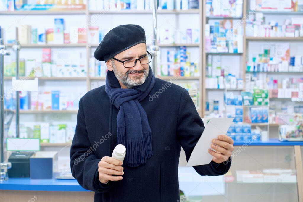 Eldery customer choosing pills, reading prescription.