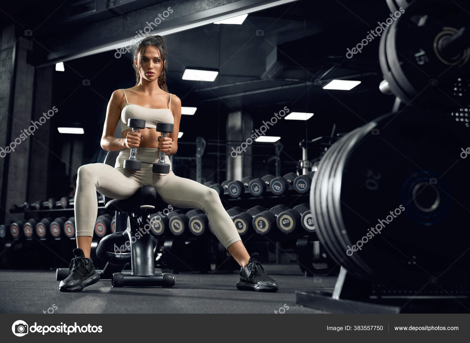 Photo of brunette sportswoman has rest after fitness training sits
