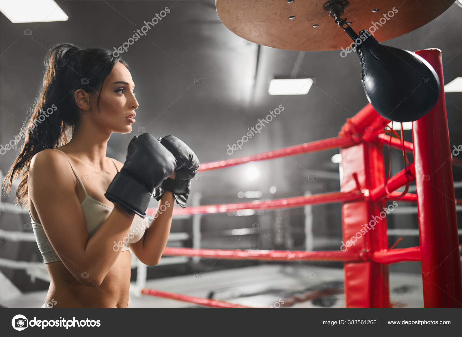 Female boxer hitting small punching bag. Stock Photo by ©serhii.bobyk