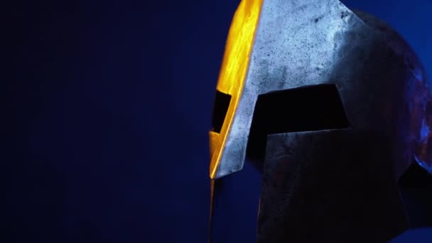 Motion of iron ancient helmet in darkness. — Stock Video