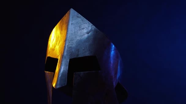 Средневековый металлический шлем, изолированный в темноте. — стоковое видео