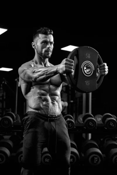 Portrait of bodybuilder holding weights straight out. — Stok Foto