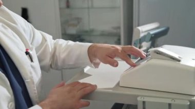 Yakın çekim bir beyaz steril sabahlık cerrah tıbbi ekipman ile bir hastanede çalışıyor. Bir doktor bir klinik laboratuvar kan testi gerçekleştirir.
