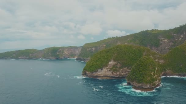 Luchtfoto van Kelingking Beach op de hoogte van de wolken. Nusa Penida, Bali, Indonesië. Travel concept. — Stockvideo