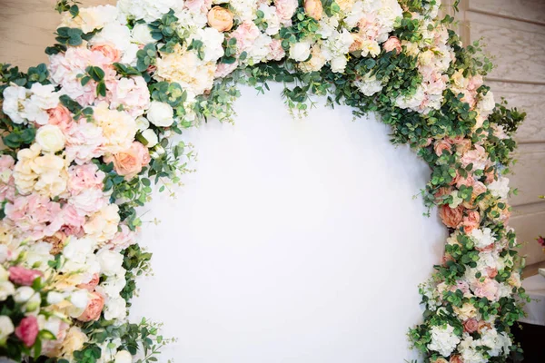 The concept of wedding decor, street decoration, wedding arch is decorated with flowers - pink and white peonies. Wedding day, ceremony place for the bride and groom, decor, flowers, florists.