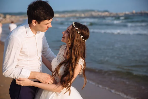 Retrato de amantes recién casados se miran y pasan tiempo juntos en la playa del océano — Foto de Stock