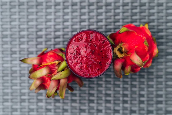 Vaso de batido de fruta de dragón y frutas sobre fondo de mesa texturizado —  Fotos de Stock