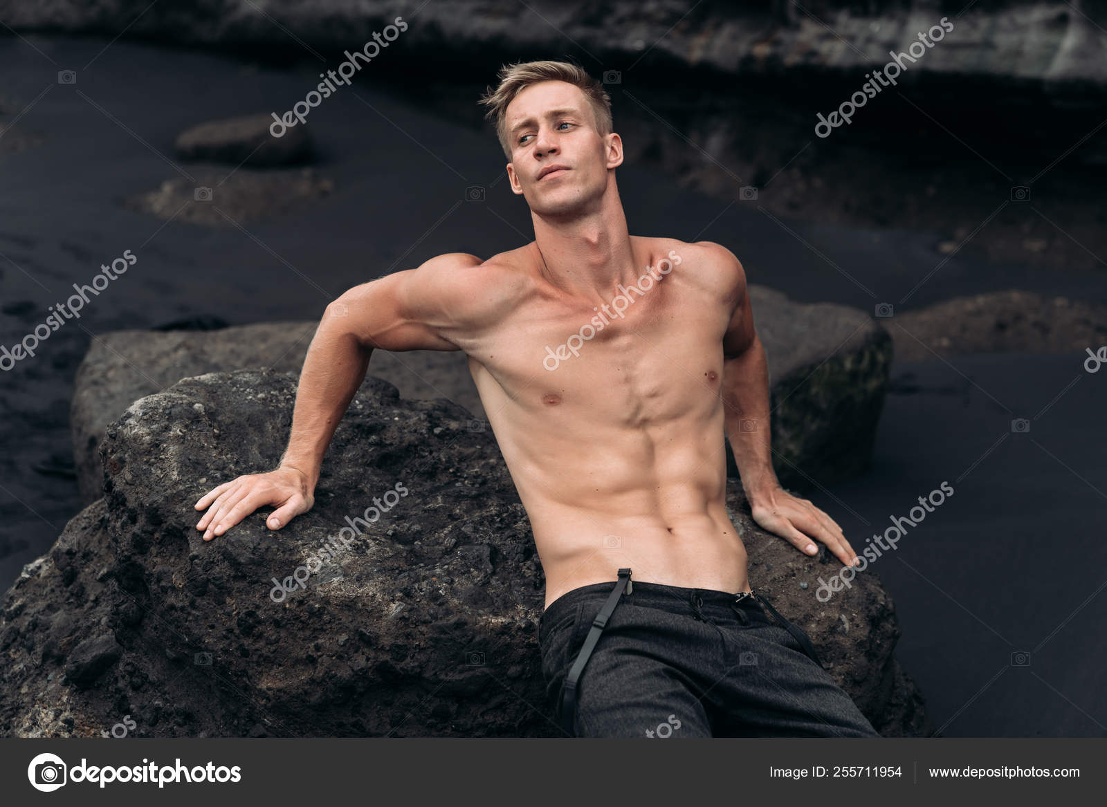 naked ru boys model Portrait of young man with naked torso siting on rocky beach with black  sand. — Stock Photo © rmano.mail.ru #255711954