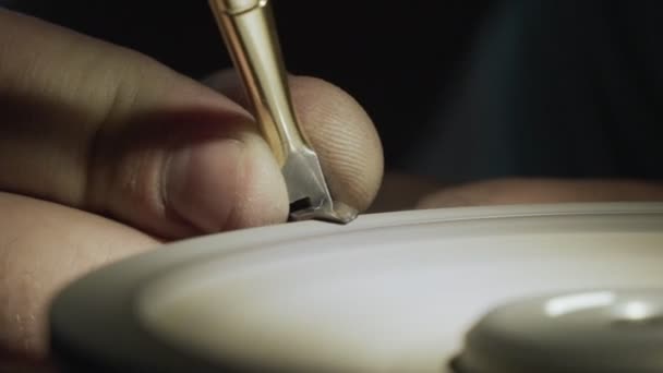 Close-up, worker sharpens nail scissors on a grindstone, slow-motion. — Stock Video